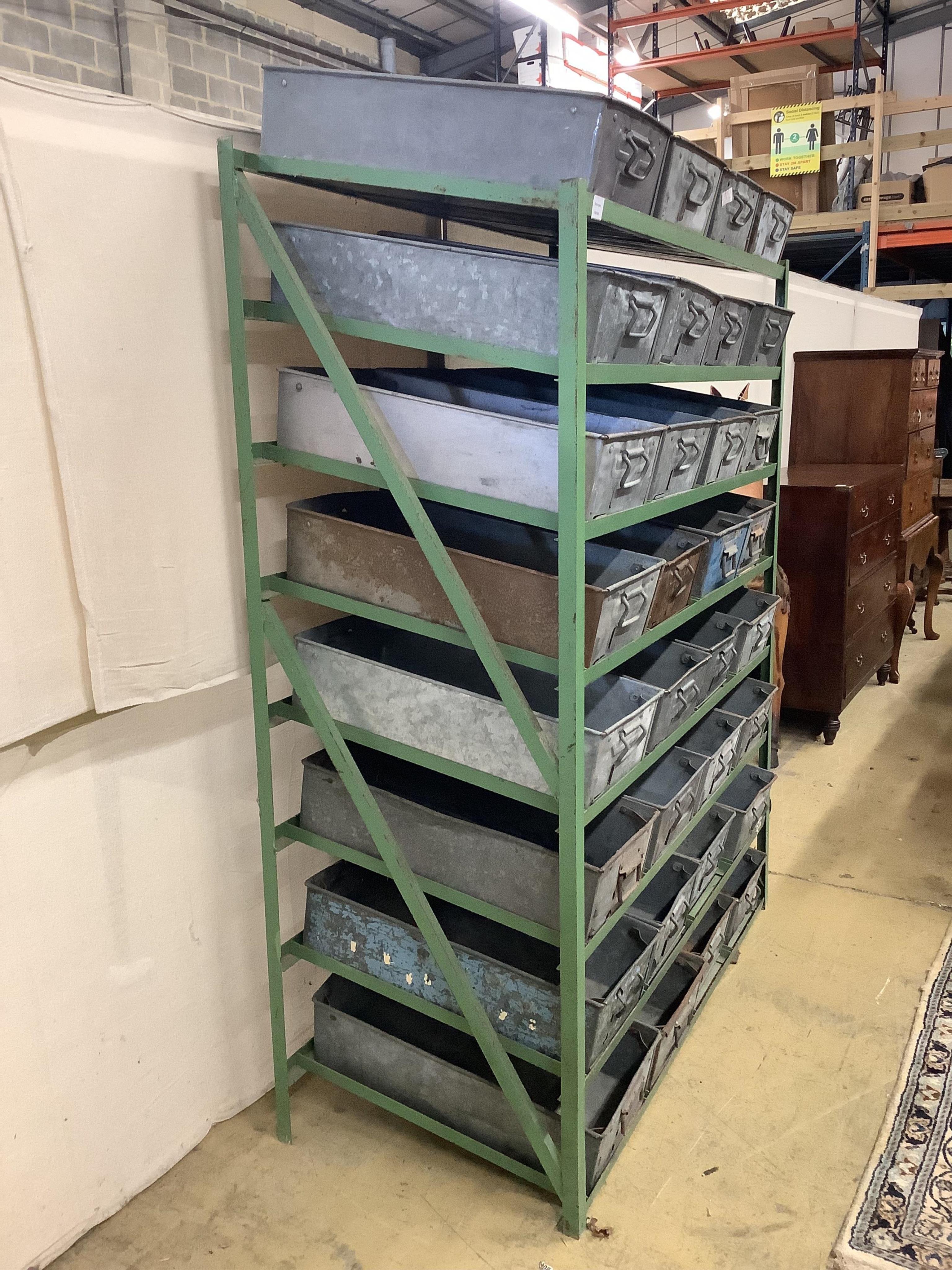 An industrial painted wrought iron unit housing thirty two rectangular galvanised containers, width 134cm, depth 63cm, height 186cm. Condition - fair